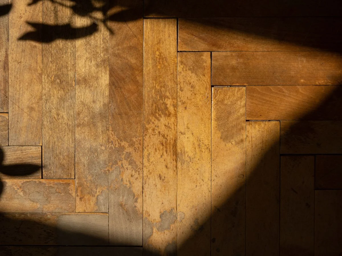 A rustic herringbone wood floor